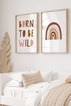 two framed pictures hang on the wall above a bed in a room with white walls