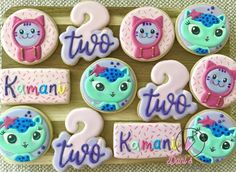 decorated cookies are arranged on a wooden board with the words two, three, and five