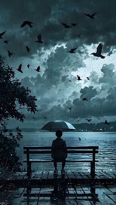 a person sitting on a bench in the rain with an umbrella and birds flying overhead