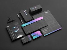 an assortment of business cards and stationery designed to look like black paper with metallic foil