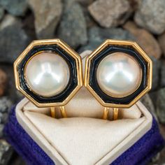 These fabulous vintage clip-on earrings feature an octagonal shaped 18K yellow gold frame accented with one (1), bezel set, cultured mabé pearl bordered with black onyx inlay. The earrings measures 20.1mm X 20.2mm and are finished with hinged omega backs for non-pierced ears. Art Deco Clip-on Jewelry For Formal Occasions, Clip-on Art Deco Jewelry For Formal Occasions, Formal Art Deco Clip-on Jewelry, Classic Cabochon Clip-on Earrings For Formal Occasions, Classic Cabochon Clip-on Earrings For Formal Events, Classic Formal Clip-on Earrings With Cabochon, Classic Black Enamel Earrings For Formal Occasion, Victorian Style Clip-on Pearl Earrings For Formal Occasions, Classic Formal Clip-on Cabochon Earrings