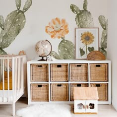 a baby's room with cactus wallpaper and wicker baskets