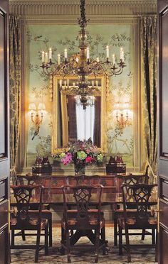 a dining room table with chairs and a chandelier