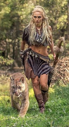 a woman in costume walking with a mountain lion