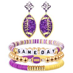 three bracelets with charms that say game day and football on them in gold, purple, and white