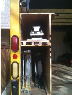 a yellow traffic light sitting next to a building