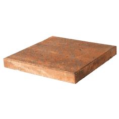 a square brick sitting on top of a white surface with no one around it,