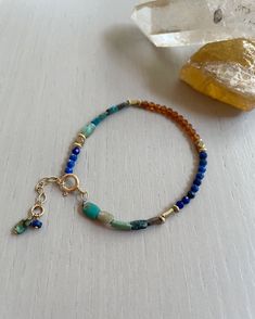 "Join my mailing list: http://eepurl.com/ci4wL and receive 10% off your next order! Find more of my jewelry on Instagram: Instagram: http://instagram.com/ruthiebeeeeee_jewelry Overview * Delicate turquoise, lapis lazuli, and hessonite garnet bracelet on durable nylon cord * Blue and orange bracelet * Natural stones and recycled brass accents * Layer with other bracelets or wear alone * Bracelet is adjustable * Finished with a gold-filled spring clasp and a tiny hand-wrapped bead and charm * Great for layering or wearing alone * Gift for her Details * * Available in the following sizes: XS (5.5-6\"), S (6-6.5\"), M (6.5-7\") L(7-7.5\") XL (7.5-8\") * Bracelet has a .5\" gold-filled extender and is adjustable ›› ›› ›› ›› ›› ›› ›› ›› ›› ›› ›› ›› ›› ›› ›› ›› ›› ›› ›› ›› ›› ›› ›› ›› ›› ›› ›› ›› Bohemian Blue Bracelets For Everyday, Bohemian Blue Bracelets With Natural Stones, Bohemian Blue Bracelet With Natural Stones, Adjustable Orange Gemstone Bracelets, Bohemian Blue Beaded Bracelets With Gemstone, Everyday Blue Beaded Bracelet With Natural Stones, Bohemian Blue Gemstone Bracelets, Blue Bohemian Gemstone Bracelets, Blue Gemstone Beads Bracelet For Everyday