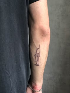 a man's arm with a tattoo on it and a hook in the middle