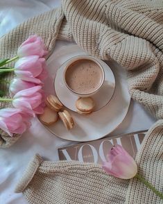 a cup of coffee and some pink flowers