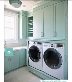 a washer and dryer in a green laundry room