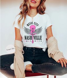 This western shirt is the perfect Nashville Tshirt. Add our Nashville shirt to your country music shirt wardrobe.  ❤︎ SHIRT QUALITY You will love the soft cotton and quality print of our shirts! We use Bella Canvas 100% ringspun cotton shirts that are super soft. Athletic and Black Heather are 90% combed and ring-spun cotton, 10% polyester ❤︎ PRINT QUALITY We use Direct to Garment Printing with high quality ink. Our shirts are printed in California.  ❤︎ SIZING  Adult Unisex Shirt: This Bella Can Casual Pre-shrunk Shirt For Music Festivals, Casual White T-shirt For Country Concerts, White Cotton Music-themed Shirt, White Band Merch T-shirt For Country Concerts, Casual Fan Merchandise Shirt For Music Festivals, Pre-shrunk Shirt For Music Festivals And Concerts, Music-themed Fan Merchandise Short Sleeve Shirt, Music-themed Cotton Shirt Fan Merchandise, Music-themed Cotton Fan Merchandise Shirt