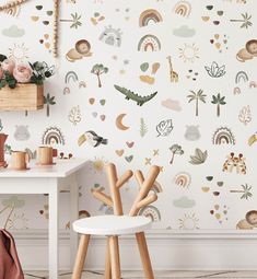 the wallpaper in this room is decorated with animals, trees and rainbows on it