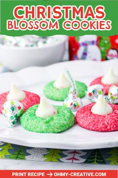 christmas blossom cookies on a plate with white frosting and green sprinkles