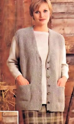 a woman standing in front of a wooden wall wearing a sweater and plaid pants with her hands on her hips