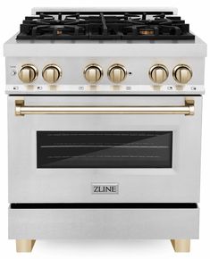 a white and gold stove top oven with two burners on the front, and four burners on the back