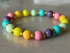 A pastel rainbow elastic glass bead bracelet, with metallic gold accent spheres to add some magic. This bracelet compliments any color and adds some delicate but playful touches to any bland outfit. If you'd like to order anything custom, which I also make, contact me at: -210-773-2555 -Vanitx@yahoo.com -message me from my shop (VCDesignsOnline) Glass Bead Bracelet, Glass Beaded Bracelets, Gold Accent, San Antonio Tx, Pastel Rainbow, Bead Bracelet, Glass Bead, Metallic Gold, San Antonio