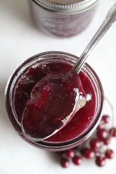 a spoon in a jar filled with cranberry sauce