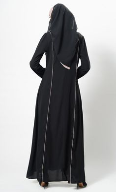 Featuring a flared elegant long abaya dress in nida fabric with contrast color flared panels on the sides and trims on the front. It has an A line silhouette perfect to be worn as casual everyday abaya.FIT : Relaxed fit.COMPOSITION : Nida.CARE : Dry clean only. Everyday Abaya, Line Silhouette, Black Abaya, Hijab Caps, Open Abaya, Mens Items, Abaya Dress, Womens Tunics, Casual Everyday