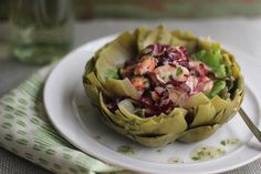 a white plate topped with an artichoke salad