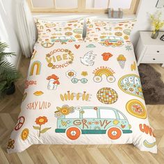 a bed room with a neatly made bed covered in colorful doodles and cartoon animals