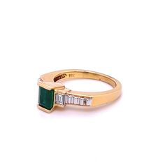 Ladies style Emerald-cut Colombian Emerald mounted in 18k solid yellow gold ring setting with baguette-cut diamond accents. A superb quality Emerald with a vivid, deep green, color hue. The Emerald is mounted in a half-bezel elevated setting, giving the optics of a larger carat size.   Certificate of appraisal included upon request.        Ring Details:  ✔ Ring Size: 8 U.S. (adjustable)  ✔ Ring Weight: 6.5 grams ✔ Gold Purity: 18K   Emerald Details:  ✔ Natural mined Emerald ✔ Cut: Emerald  ✔ Wei Classic Green Baguette Cut Diamond Ring, Classic Green Diamond Ring With Baguette Diamonds, Classic Green Emerald Ring With Baguette Diamonds, Yellow Gold Emerald Ring With Baguette Diamonds, Green Emerald-cut Diamond Ring Channel Set, Green Emerald Cut Diamond Ring Channel Set, Green Emerald Ring With Baguette Cut, Green Emerald Ring With Baguette Diamonds, Green Emerald Cut Emerald Ring With Baguette Diamonds