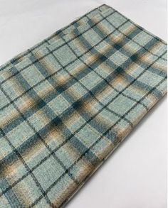 a blue and brown checkered tie laying on top of a white table