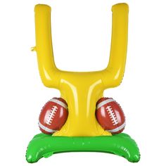 an inflatable football stand with two balls on it's legs and one ball resting on the base