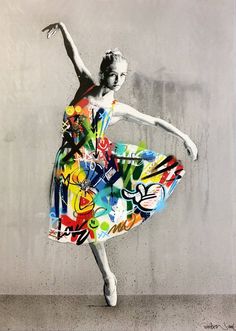 a woman in a colorful dress is dancing with graffiti on the wall behind her,