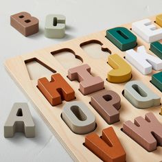 wooden letters and numbers are laid out on a table