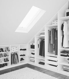 a white closet filled with lots of clothes and shoes