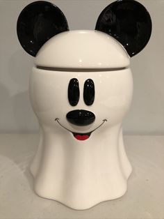 a white face with black ears on it