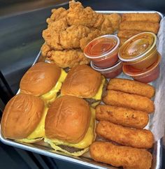 a tray filled with lots of different types of burgers and chicken nuggies