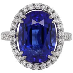 Beautiful cocktail ring set with an oval shaped tanzanite weighing a total of 12.90 carats in a four double claw open back setting. The tanzanite is mounted in the centre of a halo, claw set with fine quality round brilliant cut diamonds. The shank is then set with six round brilliant cut diamonds on either side as well as added diamonds mounted in the back of the rings setting. There are fifty diamonds total to accompany the tanzanite weighing 1.15 carats and are all mounted in 18 carat white g Tanzanite Diamond Ring, Diamond Cocktail Ring, Tanzanite Diamond, Wedding Accessories Jewelry, Diamond Cocktail Rings, Shiny Things, Gem Stones, Pretty Rings, Gorgeous Jewelry