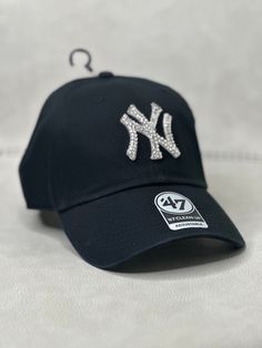 This is a black New York Clean Up adjustable hat that is hand embellished with translucent silver Swarovski style crystals on the front logo. This hat features over 150+ Swarovski style crystals.  - 100% Cotton - Matching fabric strap & buckle  - One Size Fits All - Raised Embroidered Logo - 150+ Swarovski style translucent silver crystals individually placed by hand - Ready to ship in 1 week from San Diego, Ca Ms Krazie, Hat New York, Bling Hat, Black New York, Fabric Strap, Adjustable Hat, Christmas List, Trucker Cap, Clean Up