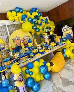 a birthday party with yellow and blue balloons, minion decorations and minionsette characters