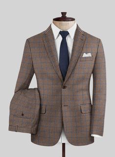 On the hunt for a timeless and fashionable suit that guarantees you'll turn heads? Look no further than our Reda Baez Brown Checks Wool Suit. Crafted from pure wool, it gives you natural warmth and unparalleled comfort, showcasing meticulous craftsmanship. This classic suit is your ticket to making an impression at any event in a professional or social setting.  Look Includes    Reda Baez Brown Checks  Wool  Fabric  Two Button Jacket Style  Notch Lapel   Horn   Brown  Buttons  Single Vent  Three