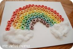 a rainbow made out of cereal krispy kreme on a piece of paper