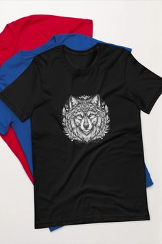 three different colored t - shirts with an image of a wolf on the front and back