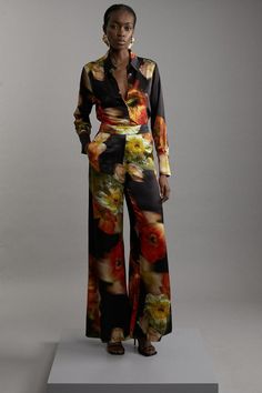 {@@=Ist.Core.Helpers.StringHelper.ToProperCase("Experience sleek tailoring in a pair of tall flared trousers, with a flattering, flared fit and a comfortable high waistline. The vibrant floral print makes a statement, ideal for elevated evening plans and days that require something a little extra. Style it with anything, from a blouse and blazer for an office outfit ideal for big meeting days, or with a T-shirt and trainers for a more laid back approach. Tall Floral Satin Woven Flared Trouser Hi Floral Pant Suit Women, Elegant Full Length Spring Flares, Elegant High-waisted Flare Pants For Spring, Fitted Silk Wide Leg Pants For Night Out, Fitted Silk Bottoms For Fall, Flower Pants Outfit, Floral Blazer Outfit, Wedding Guest Suit, Wedding Guest Suits