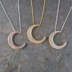 "This unique crescent moon phase pendant is available in silver or 14 k gold. So beautiful polished but equally stunning hand-finished matte, hammered or have it encrusted with diamonds. A focal piece that can be stacked with smaller pendants. It's a slide providing space for a pendant to fit into the opening. We've paired it with our bezel set moonstone. crescent moon 24 millimeters long x 19 mm wide or/ almost 1\" long x 3/4\" wide 14k solid gold or sterling silver pave Diamond encrusted Cresc Luxury Sterling Silver Moon Charm Jewelry, Luxury Sterling Silver Jewelry With Moon Charm, Luxury Sterling Silver Crescent Necklace, Elegant Diamond Sun And Moon Jewelry, Elegant Diamond Jewelry With Sun And Moon Design, Luxury Silver Crescent Jewelry, Moon Shaped Sterling Silver Jewelry With Diamond Accents, Celestial Crescent Diamond Jewelry, Silver Crescent Necklace Fine Jewelry