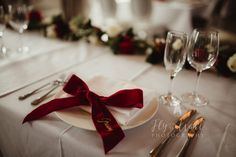 the table is set with wine glasses and silverware for an elegant wedding reception or special event