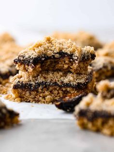 two pieces of cake sitting on top of a white plate with chocolate crumbs