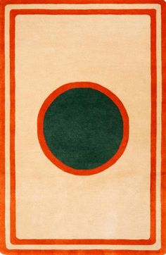 an orange and white rug with a green circle on it