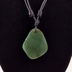 The Jade pendant is 1.4 inches in length and 1.1 inches wide on natural black polished round leather. The necklace is adjustable from 16 inches to 32 inches by sliding the knots. Jade refers to an ornamental mineral, mostly known for its green varieties. It can refer to either of two different minerals: nephrite, a silicate of calcium and magnesium, or jadeite, a silicate of sodium and aluminium. Jade is featured prominently in ancient Asian art, but also has an important place in many other cul Adjustable Pendant Necklaces With Waxed Cord, Adjustable Pendant Necklace With Waxed Cord, Pendant Necklace With Adjustable Waxed Cord, Adjustable Round Pendant Waxed Cord Jewelry, Casual Adjustable Jewelry With Round Pendant, Adjustable Sliding Knot Necklace With Round Pendant, Adjustable Round Pendant Necklace With Sliding Knot, Adjustable Green Necklace With Waxed Cord, Green Adjustable Jewelry On Waxed Cord