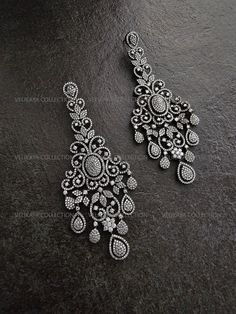 Statement chandelier earrings with an intricate Victorian design. Made with highest quality CZ diamonds and expert craftsmanship. Ideal for weddings and parties. Length - 4.25 inch Width - 1.75 inch Weight - 23 gm each ----------- CARE ----------- - Store in air tight zip lock bags - Do not expose to moisture/water - Do not spray chemicals or perfumes on the jewelry Please feel free to contact us if you have any questions. * We sell high quality imitation jewelry only. All measurements are approximate. Please note that all sales are final. Thank you Exquisite Diamond White Chandelier Earrings, Silver Earrings With Intricate Diamond Design, Elegant Diamond Chandelier Drop Earrings, Elegant Chandelier Earrings With Intricate Design For Reception, Elegant Diamond Chandelier Earrings For Reception, Diamond Chandelier Dangle Earrings, Exquisite Diamond Chandelier Earrings For Pierced Ears, Diamond Drop Chandelier Earrings, Exquisite Silver Chandelier Drop Earrings