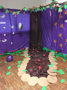 a room with purple walls and green leaves on the floor, decorated in brown paper