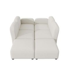 a white couch sitting on top of a white floor