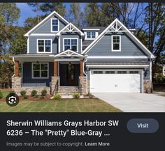 a gray house with white trim and windows