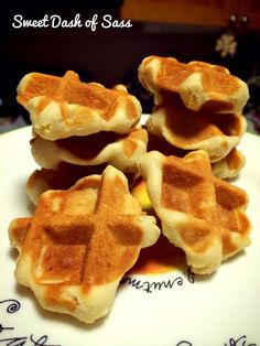 some waffles are sitting on a white plate